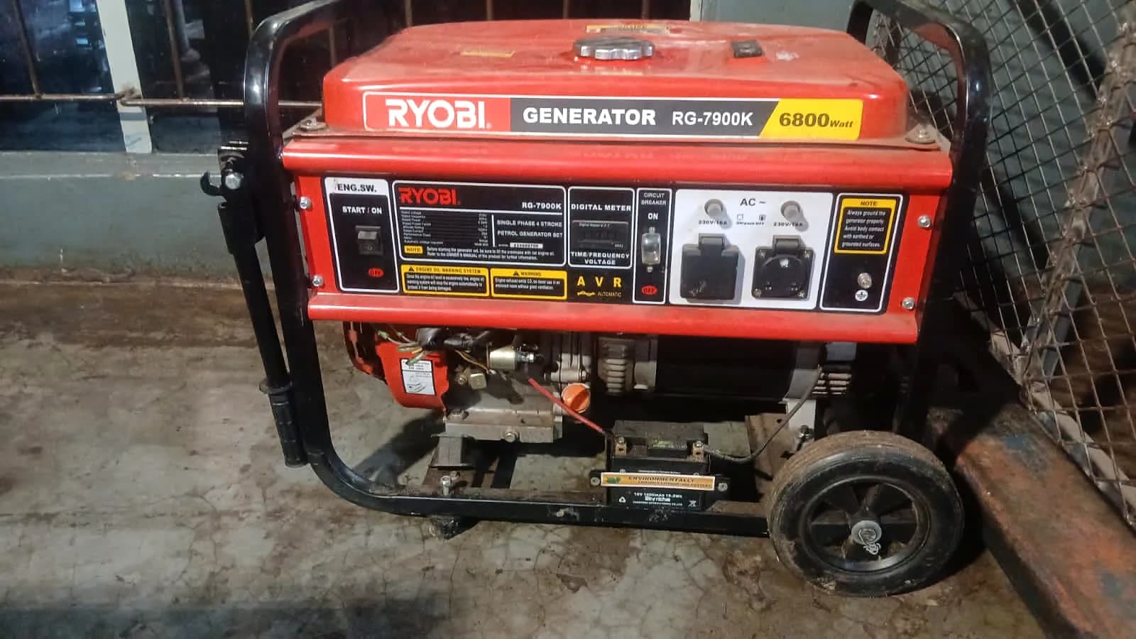 Control panel of a Ryobi RG-7900K petrol generator with its digital meter, circuit breaker, AC sockets and AVR label
